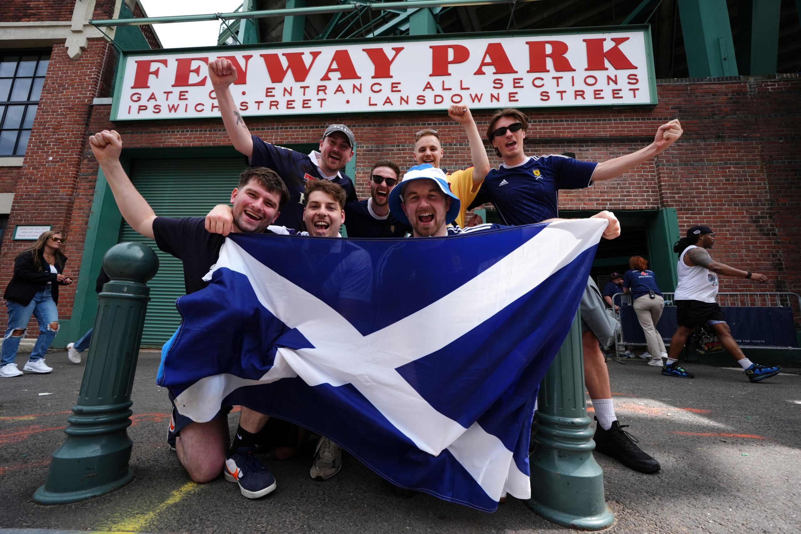 Scotland fans celebrating with a large saltire outside Fenway Park in Boston