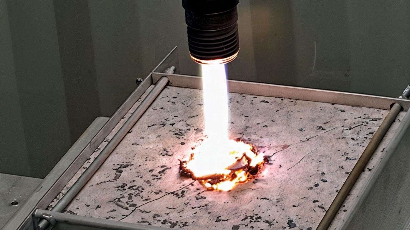 A bright beam of millimetre-waves blasts a test piece of rock.