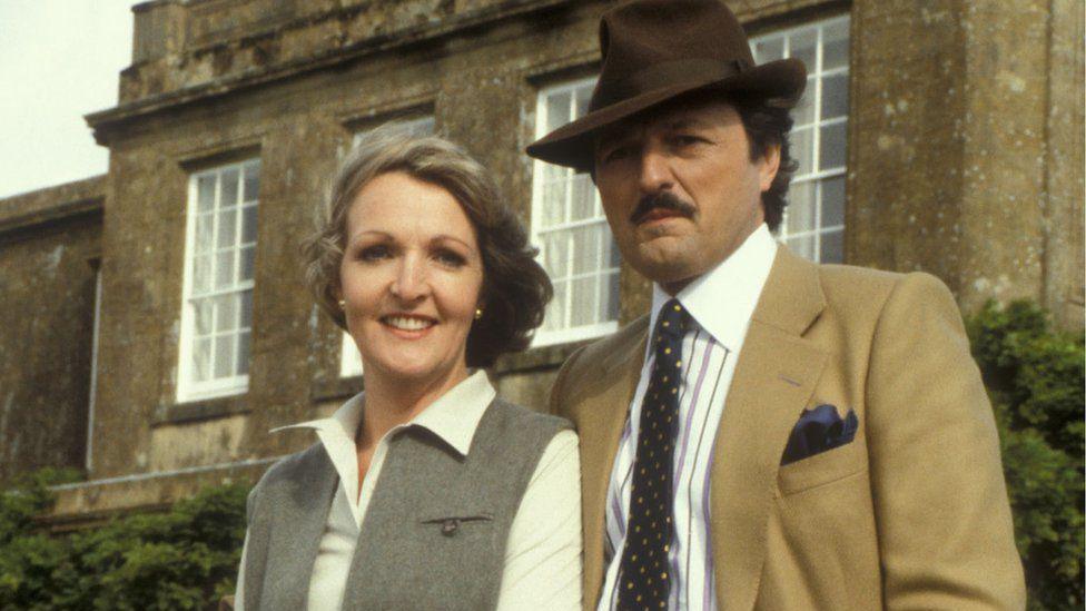 Keith and Bowles in To The Manor Born - posing in character outside their stately home