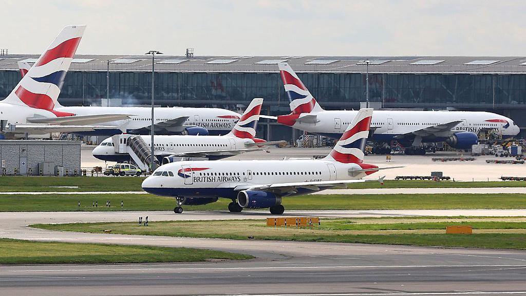 A British Airways Airbus A319 taxis near to Heathrow Airport's Terminal 5.
