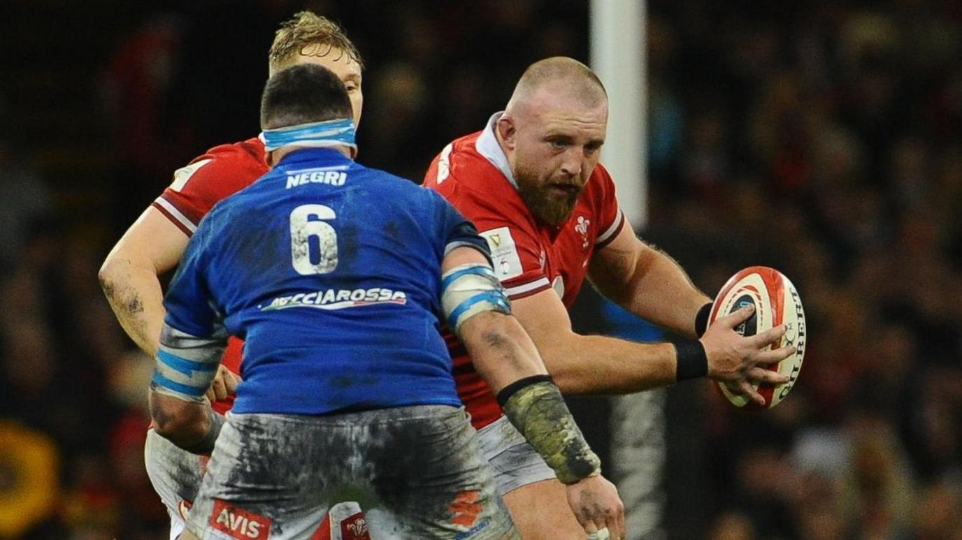 Dillon Lewis carries the ball for Wales against Italy