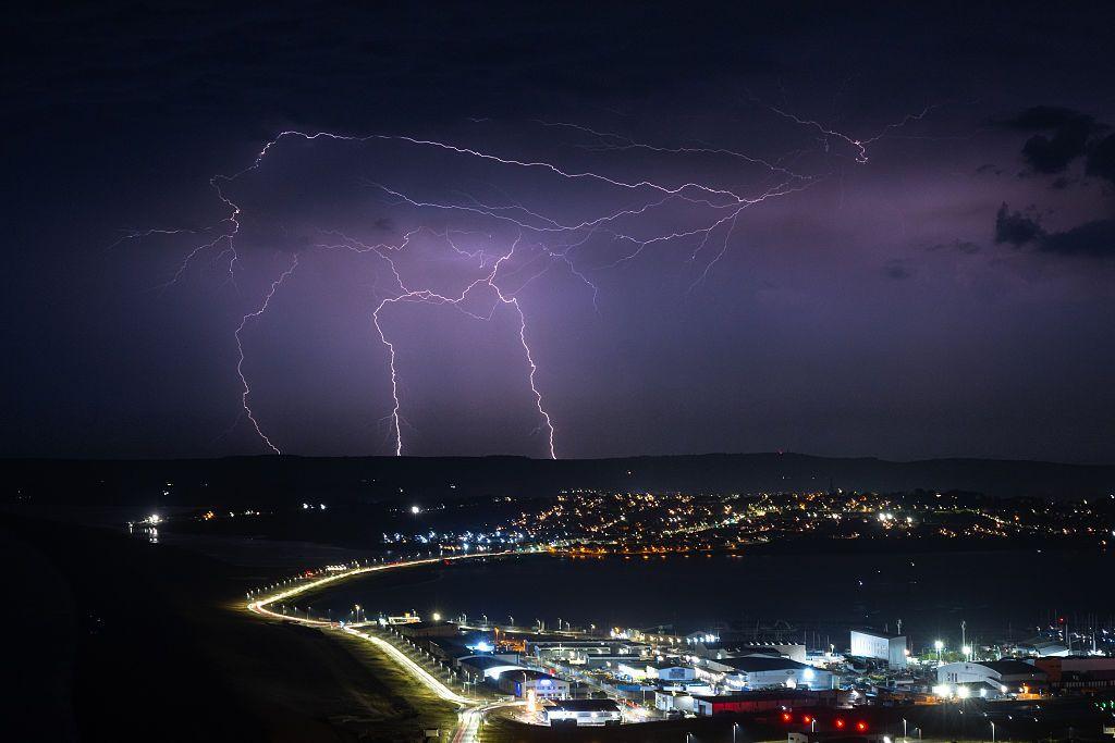 Lightning strikes are seen during a storm over Weymouth.