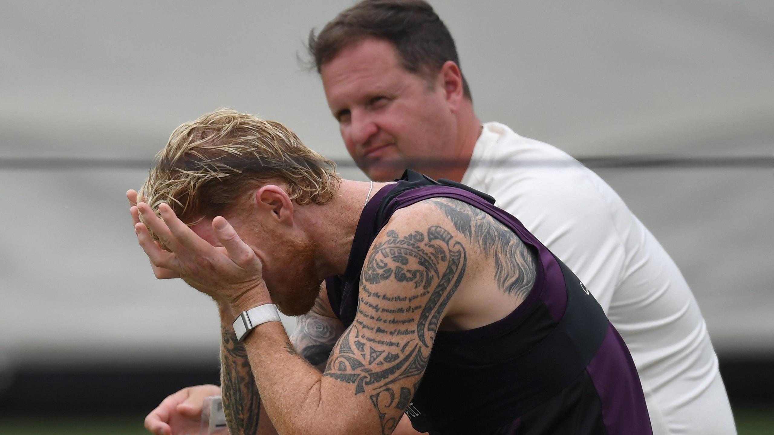 Ben Stokes holds his head in his hands, watched on by Rob Key