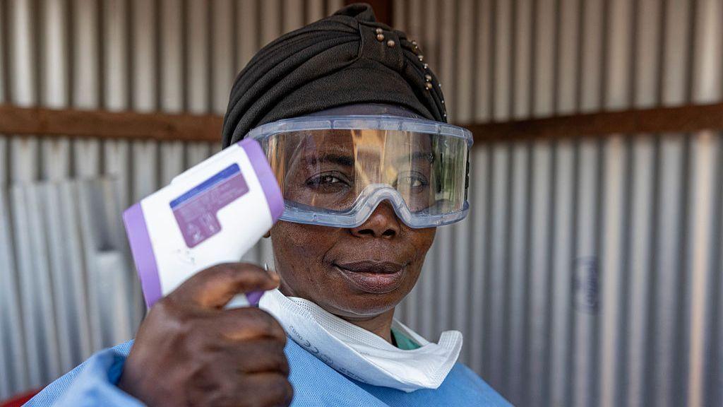 A nurse holding a temperature testing device