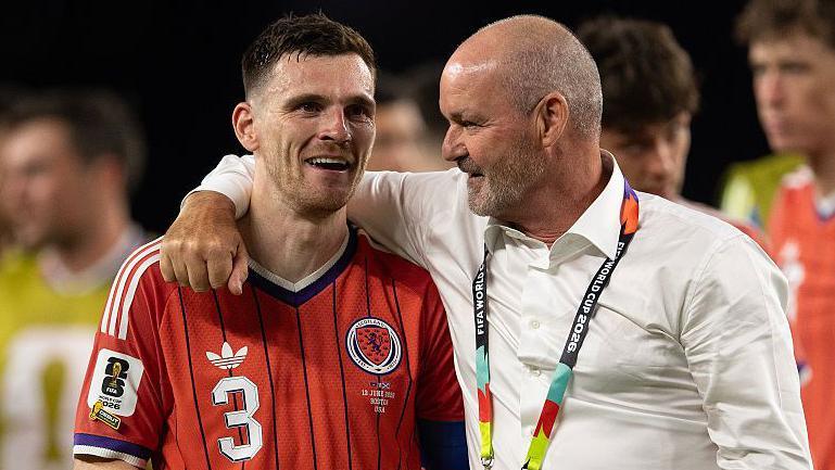 Andy Robertson and Steve Clarke celebrate Scotland's win over Haiti at the World Cup