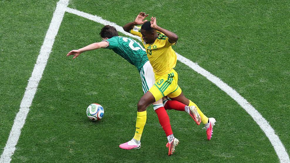 Brian Gutierrez of Mexico is fouled by Sphephelo Sithole of South Africa. Sithole was issued a red card.