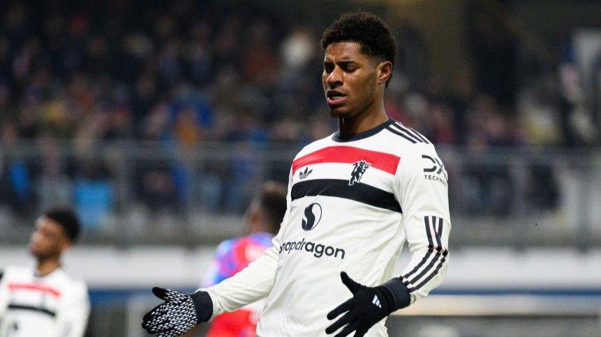 Marcus Rashford playing for Manchester United in a largely white change kit
