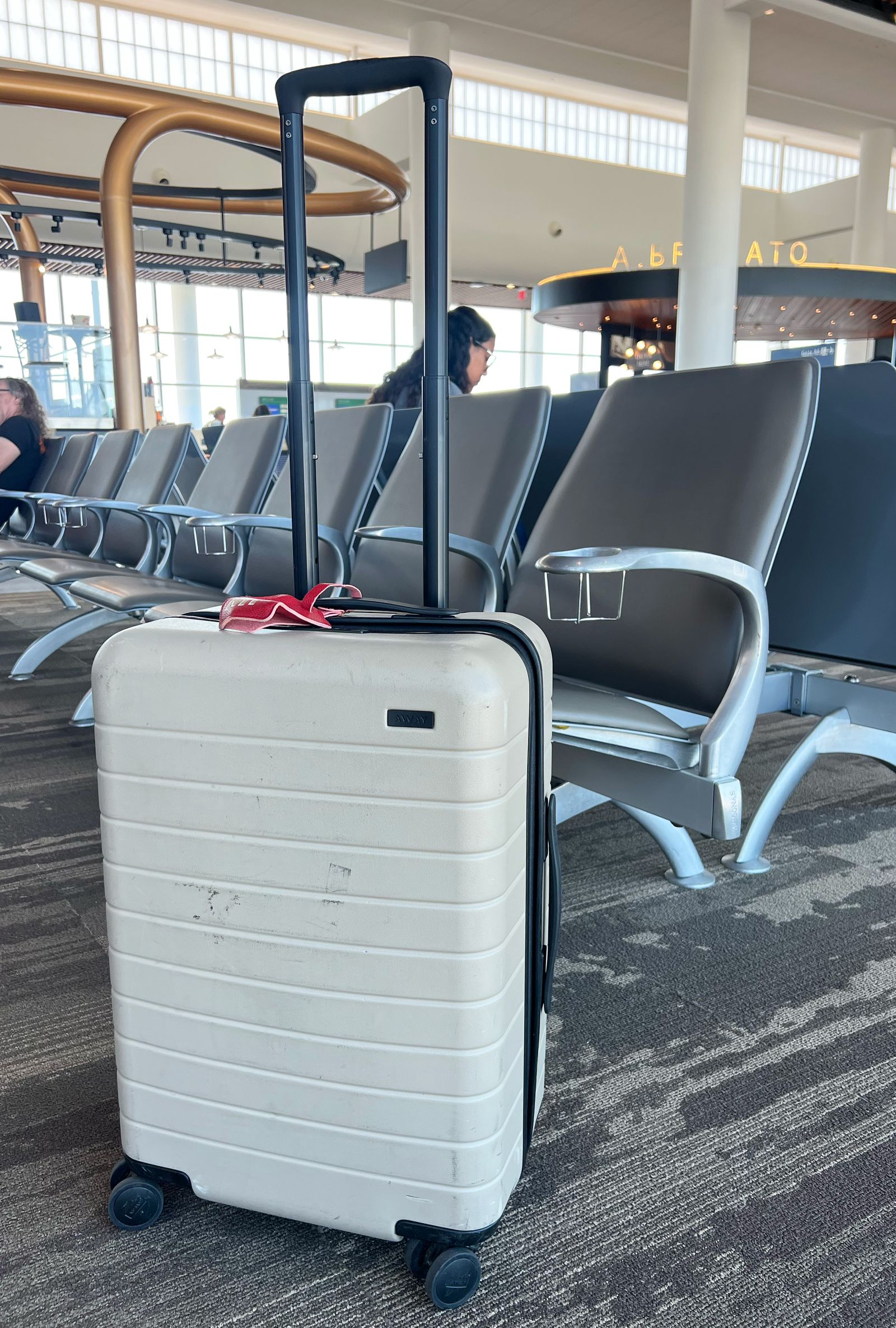 Image may contain Baggage Person Accessories Glasses Chair and Furniture