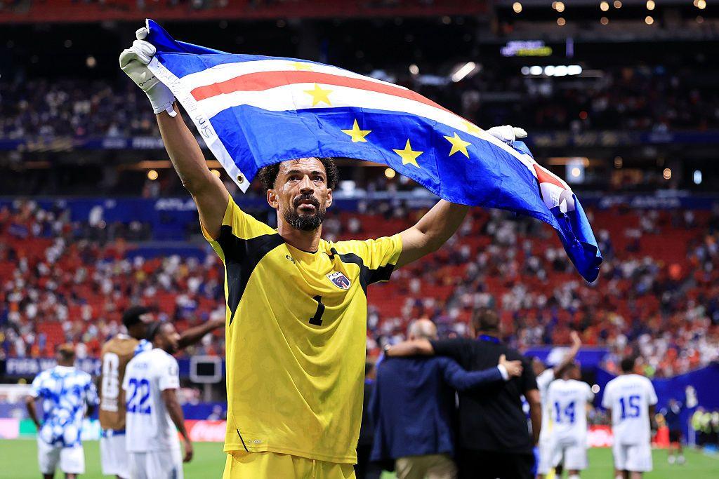 Cape Verde goalkeeper Vozinha holds up his country's blue, red and white flag