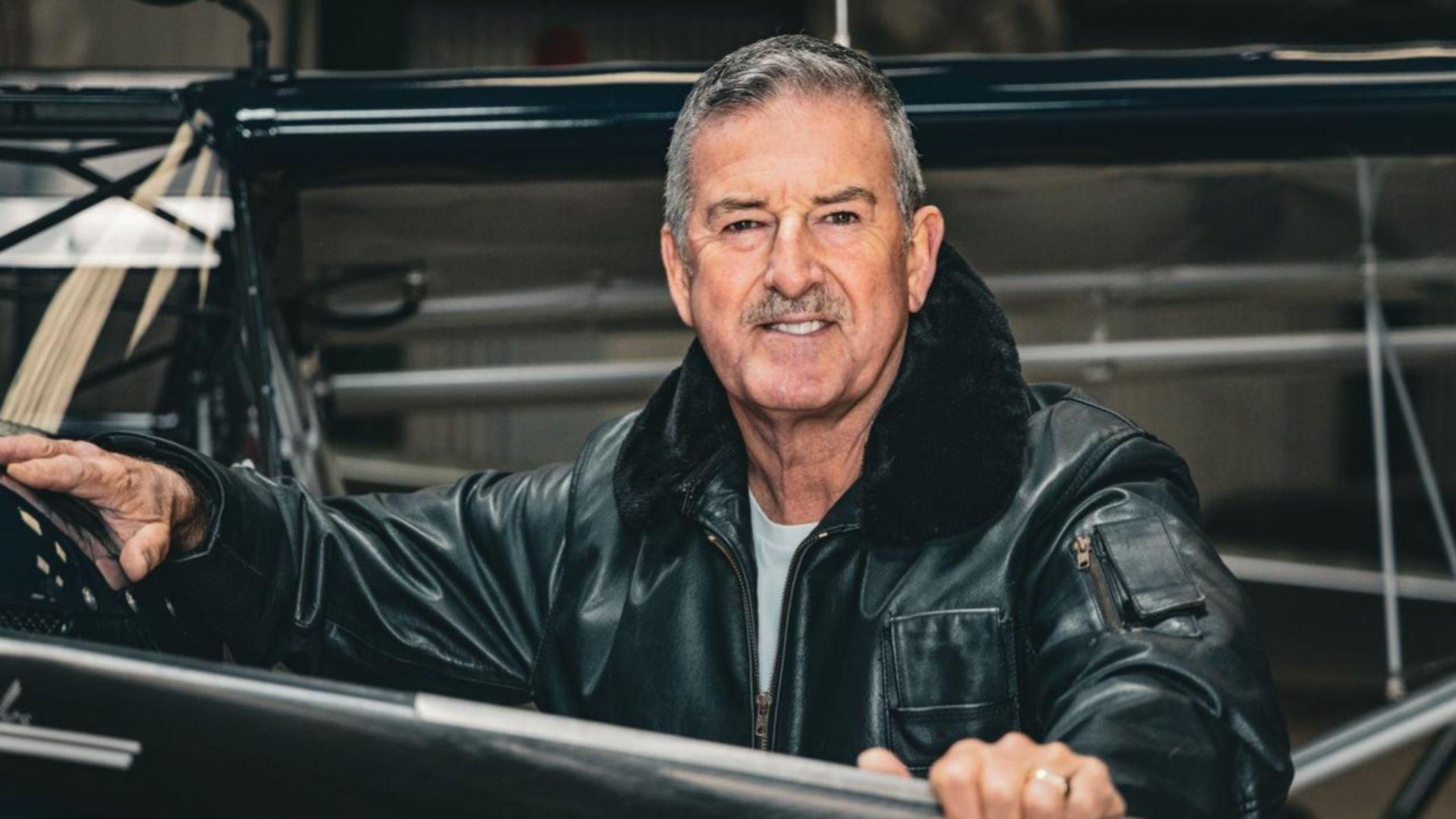 Former RAF pilot Andy Wyatt he has short grey hair and moustache and is wearing a black leather flying jacket