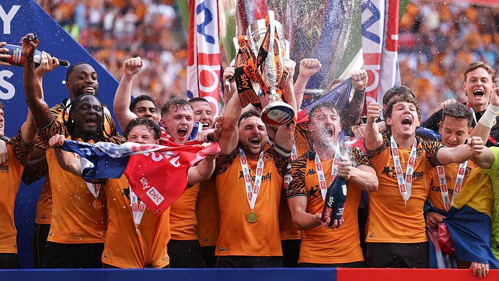 Lewis Coyle of Hull City lifts the Championship play-off final trophy after being promoted to the Premier League