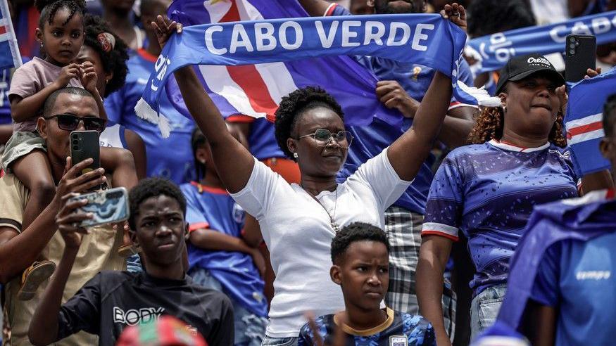 Cape Verde fans wave flags and scarves from the stands as they follow the national team's training session in Santa Cruz before the start of the 2026 World Cup