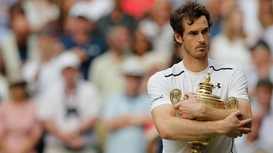 Andy Murray hugs his Wimbledon trophy