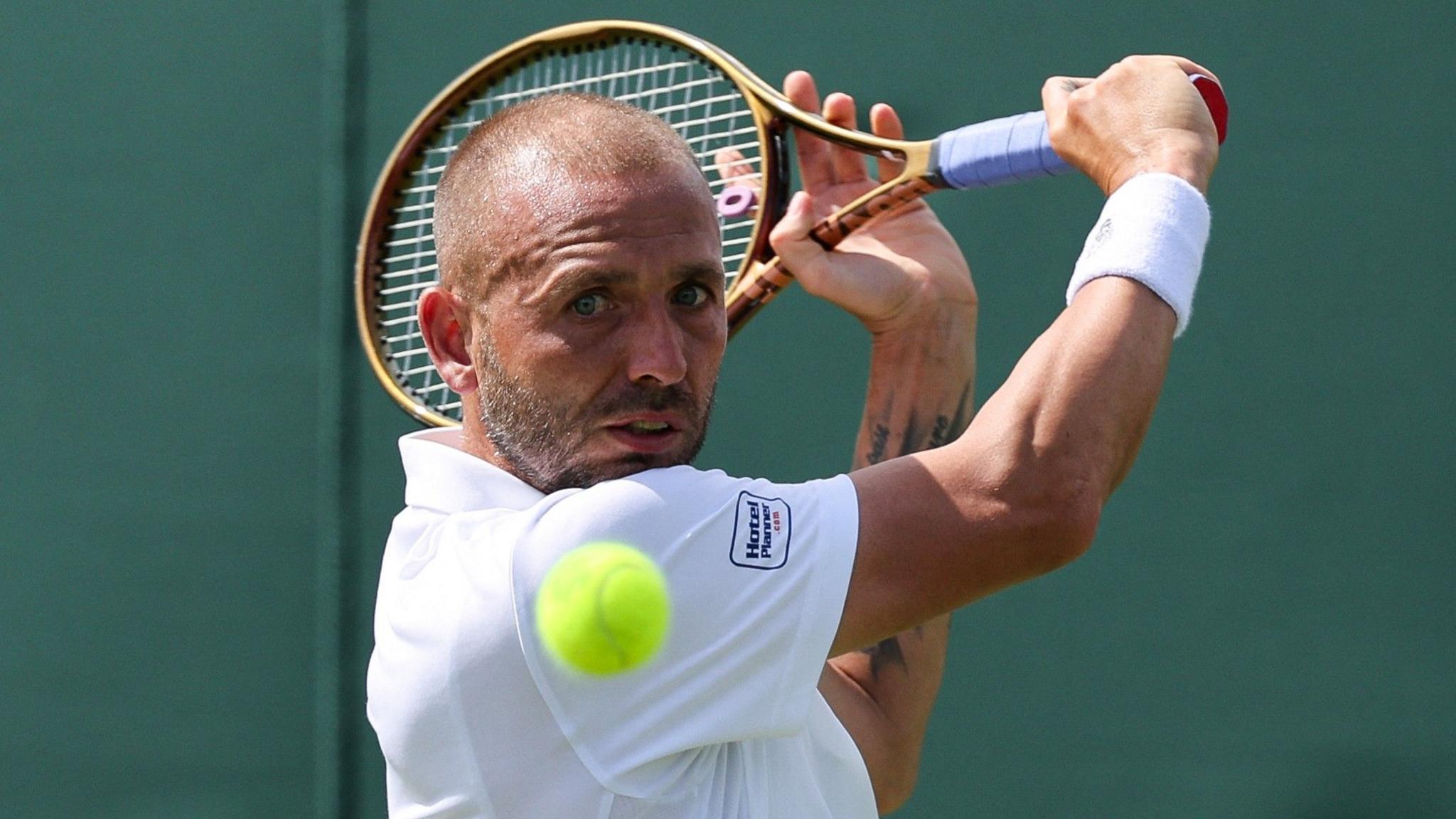 Dan Evans hits a backhand
