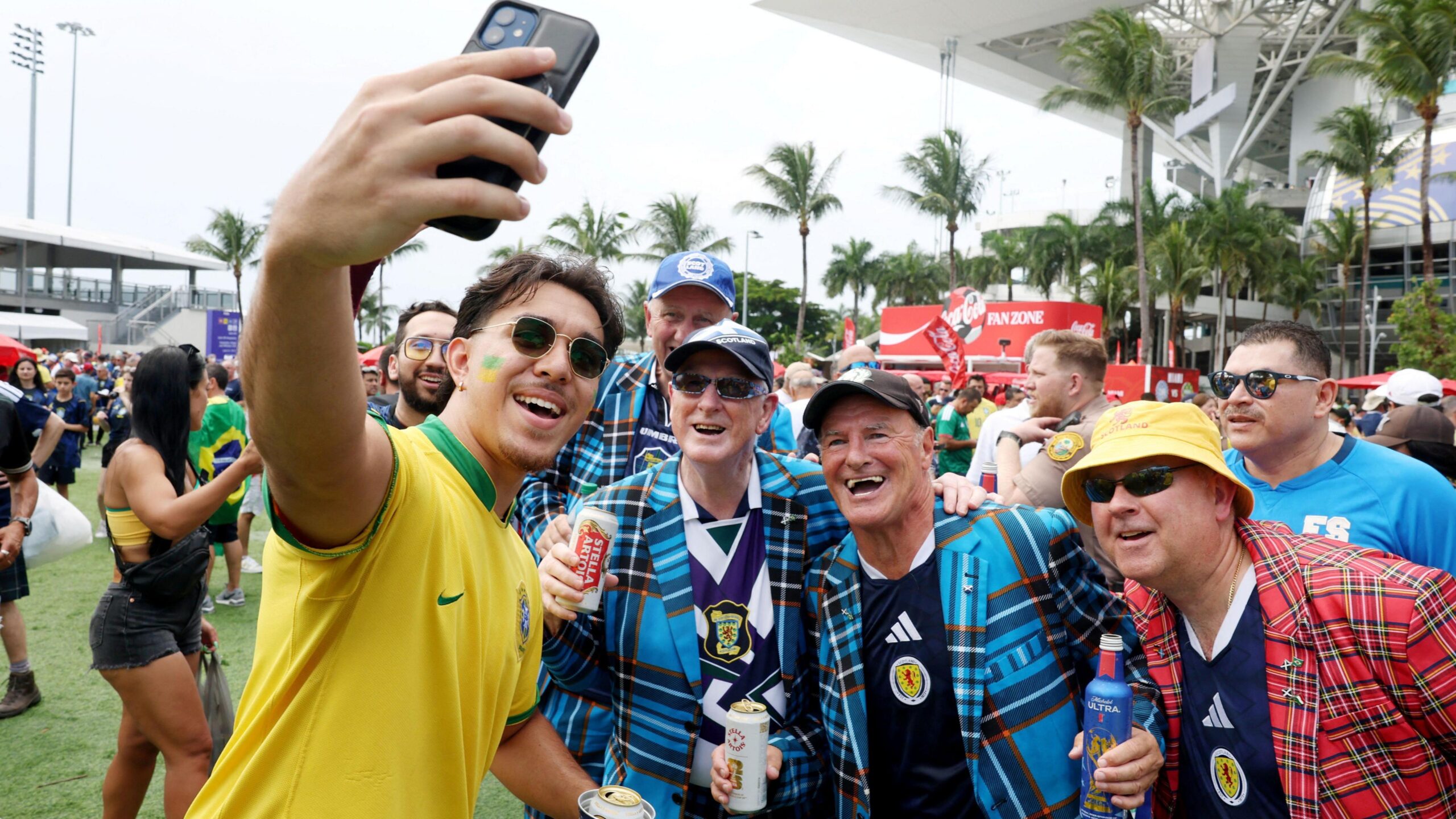 Soccer Football - FIFA World Cup 2026 - Group C - Scotland v Brazil - Miami Stadium, Miami Gardens, Florida, U.S. - June 24, 2026 A Brazil fan takes a selfie with Scotland fans outside the stadium before the match REUTERS/Paul Childs