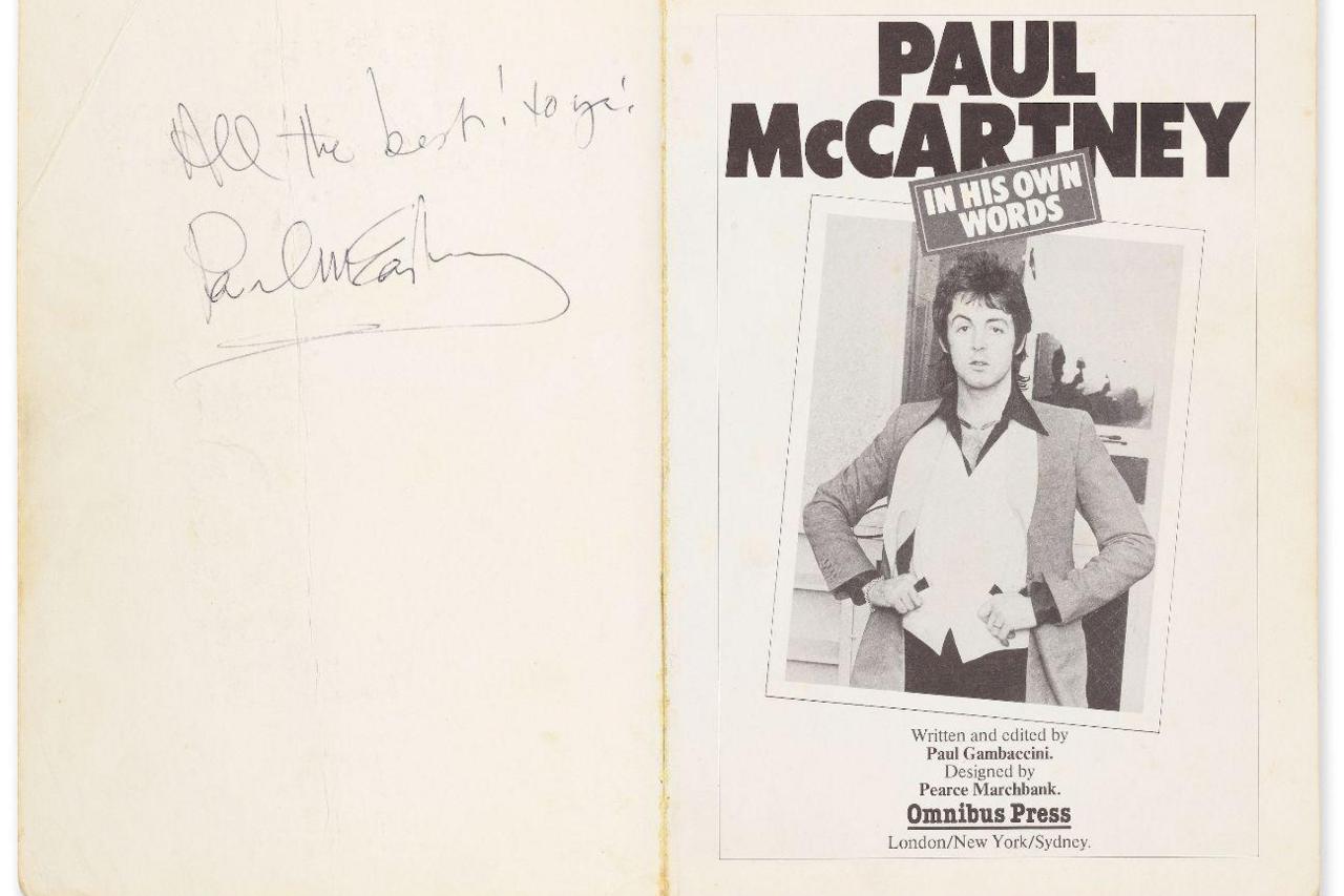 The inside front cover of a book. The pages are cream and on the inside there is a signed note from Sir Paul McCartney. On the other side there is a black and white image of Sir Paul McCartney and the headline text Paul McCartney In His Own Words