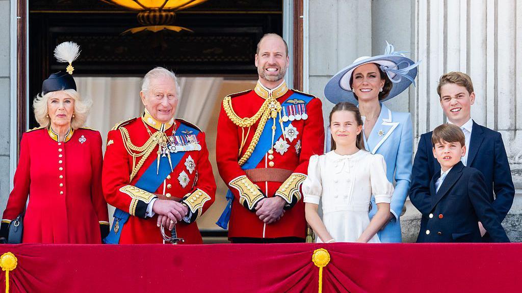 Queen Camilla, King Charles, the Prince of Wales, Princess Charlotte, the Princess of Wales, Prince George and Prince Louis stand on the balcony of Buckingham Palace.