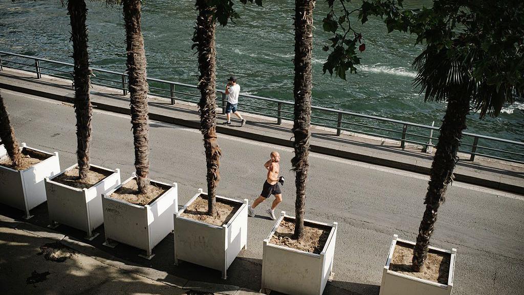 A man runs along the Seine river