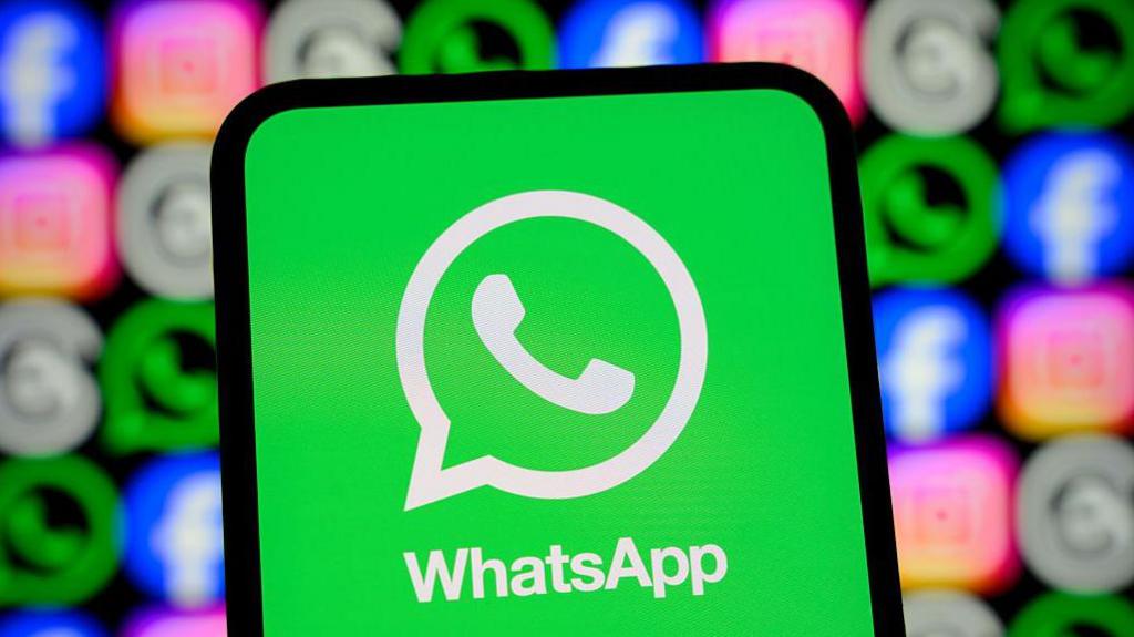WhatsApp logo displayed on a smartphone screen, with its logo shown alongside those of Meta apps Facebook, Instagram and Threads.