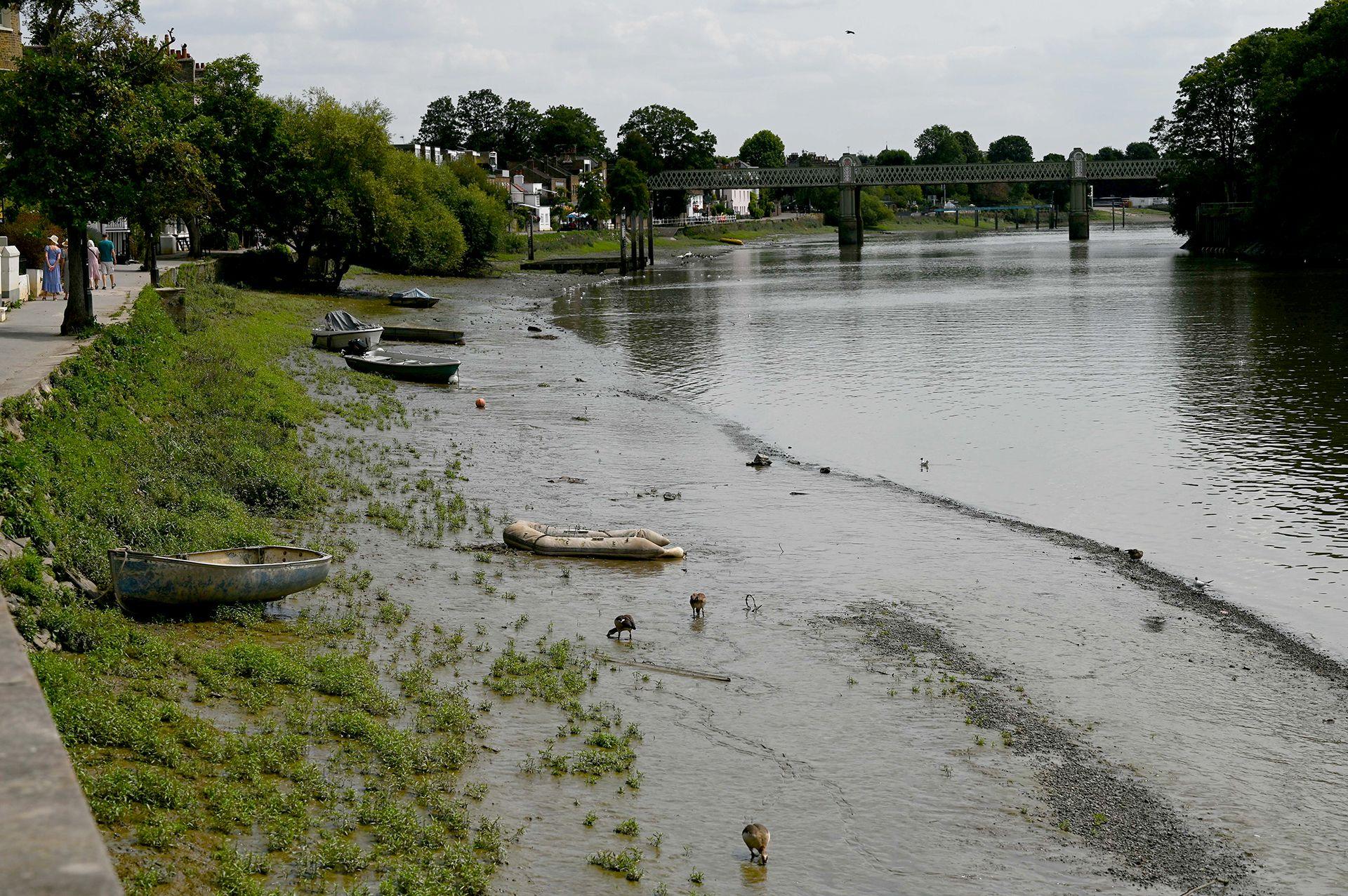 Boats are seen stranded on the exposed riverbed of the River Thames as water levels drop amid hot and dry weather conditions in London, United Kingdom, on July 24, 2026.
