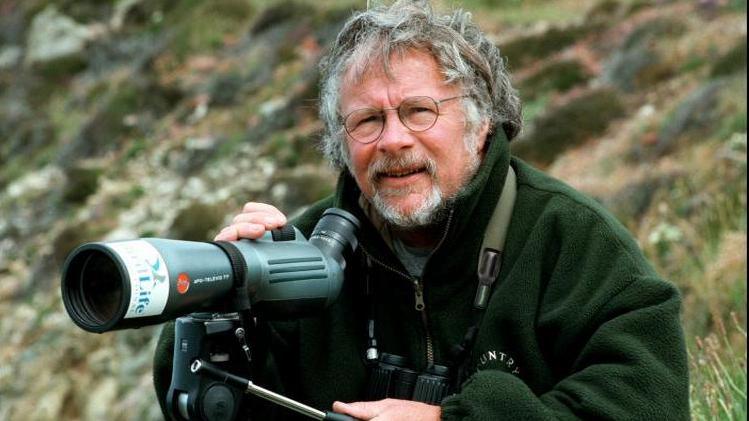 Bill Oddie out watching birds with a telescope