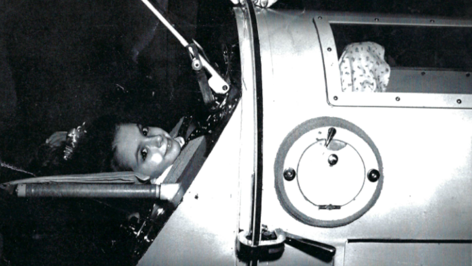 Black and white photo of of Martha Lillard in the iron lung as a child