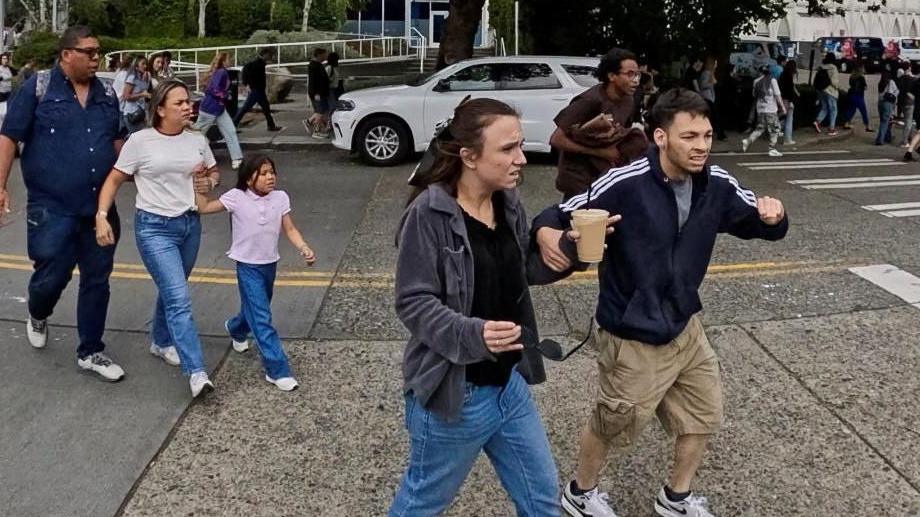 People react as they run away from the scene during an incident