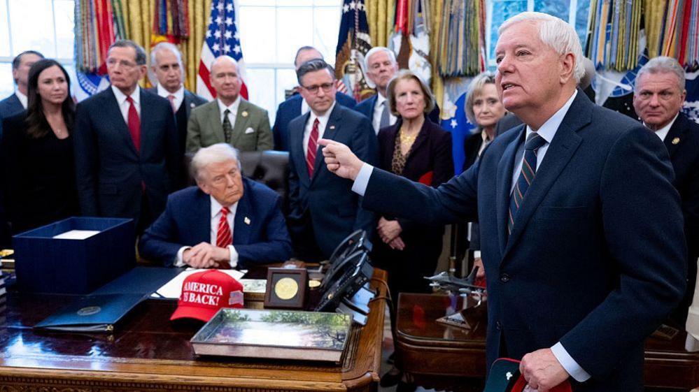 US Senator Lindsey Graham speaks to the press alongside US President Donald Trump, surrounded by members of Congress, in the Oval Office in February 2026