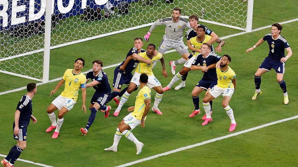 Brazil and Scotland players battle for position on a corner kick during the World Cup match at Miami Stadium