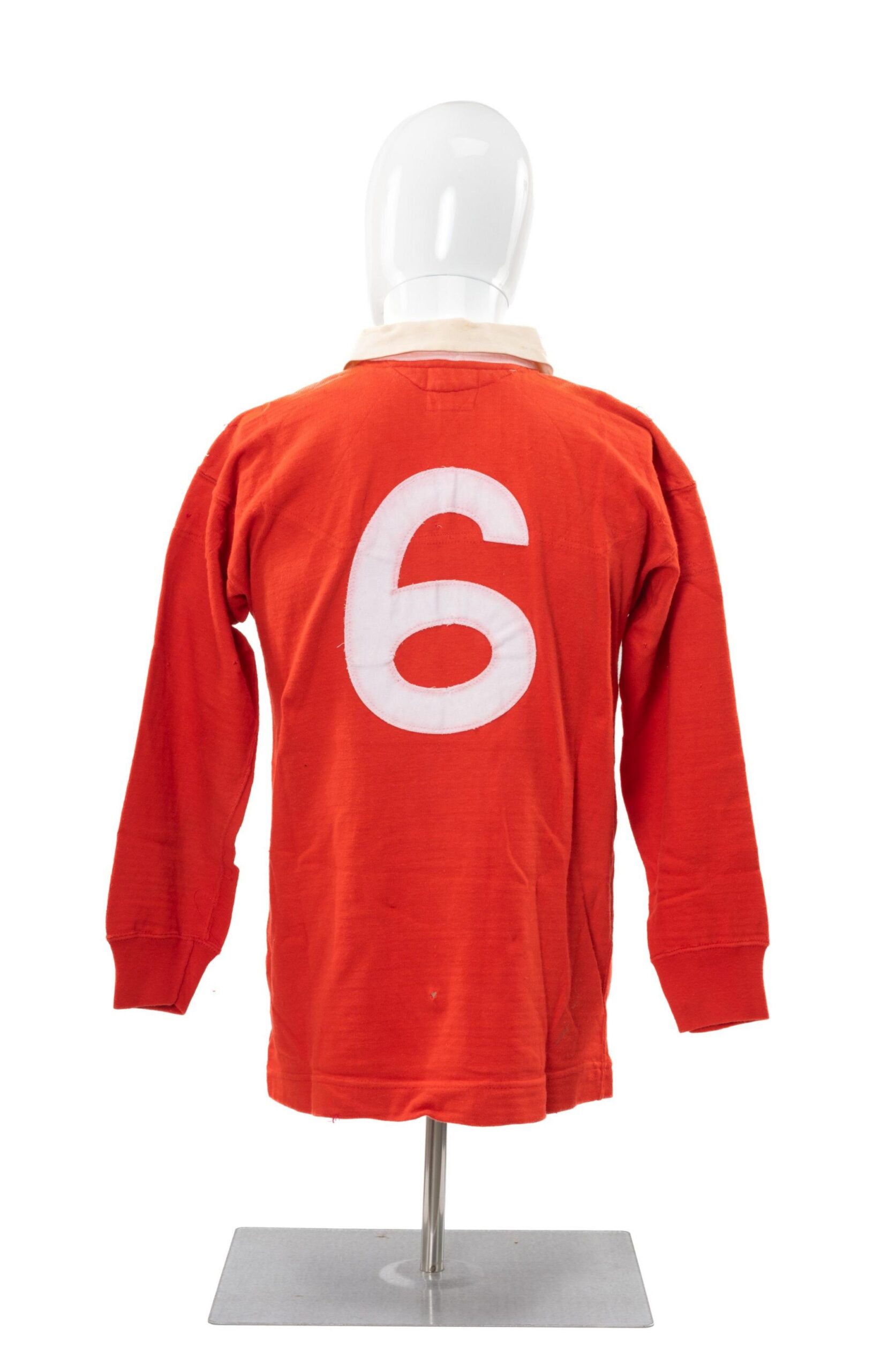 The red jersey on a mannequin seen from behind showing number 6 in white.