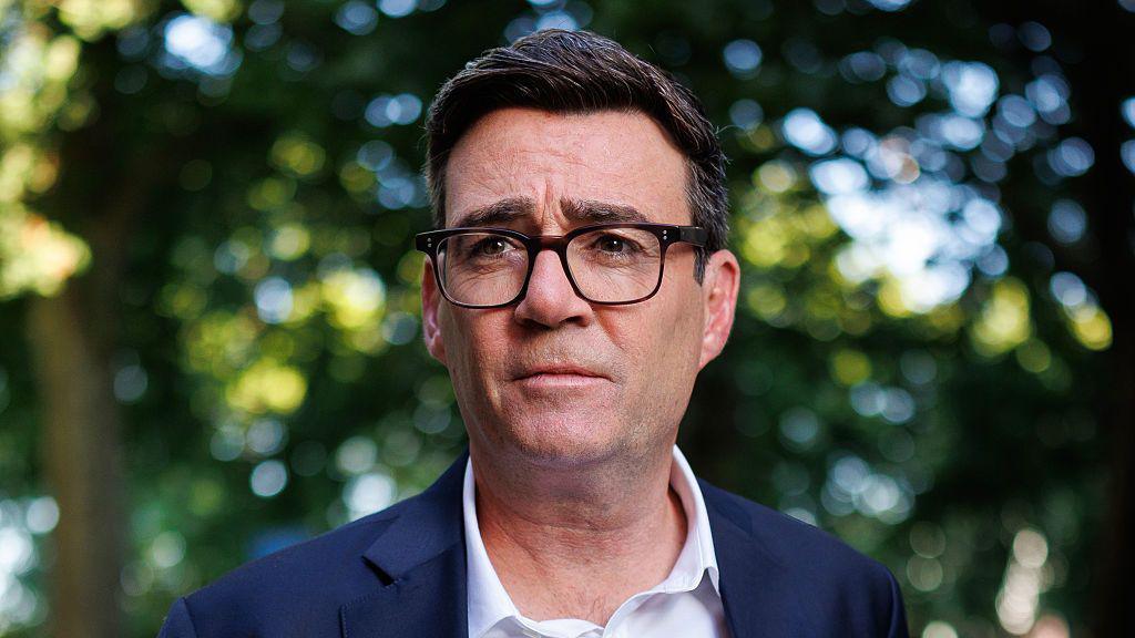 Andy Burnham in a white shirt and suit jacket.