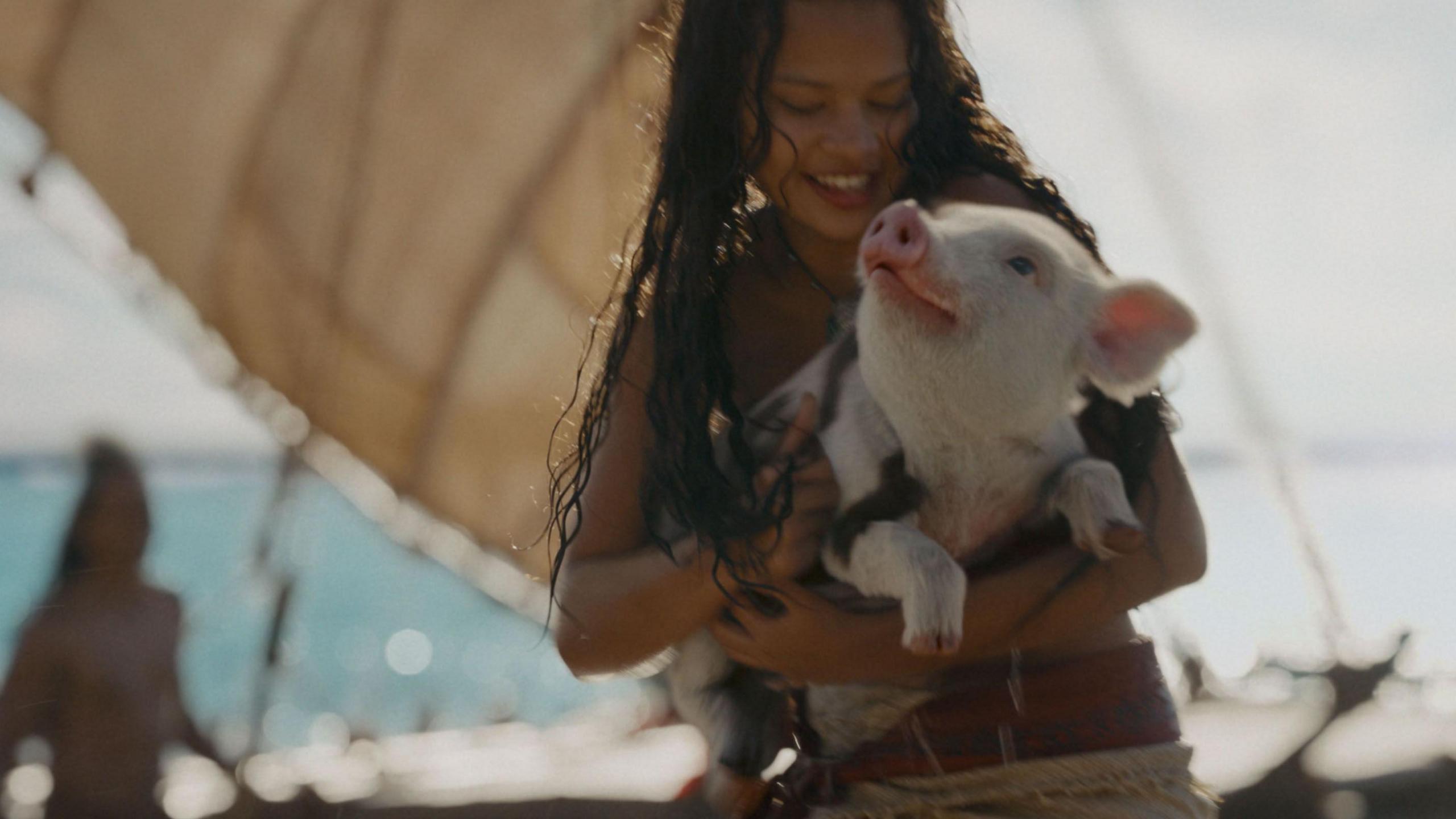 Catherine Laga'aia seen holding a pig in a still from the 2026 live-action film Moana
