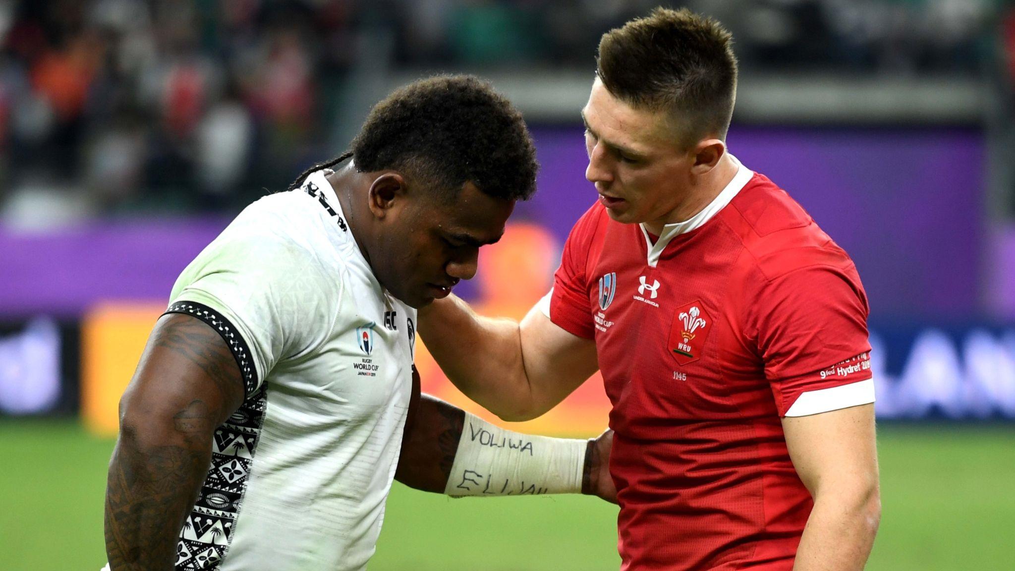 Josua Tuisova in the white of Fiji and Josh Adams in the red of Wales talk at the end of the game