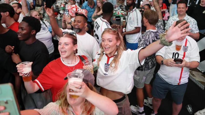 Fans watch a screening of the FIFA World Cup match between England and Congo DR at BOXPark Wembley.