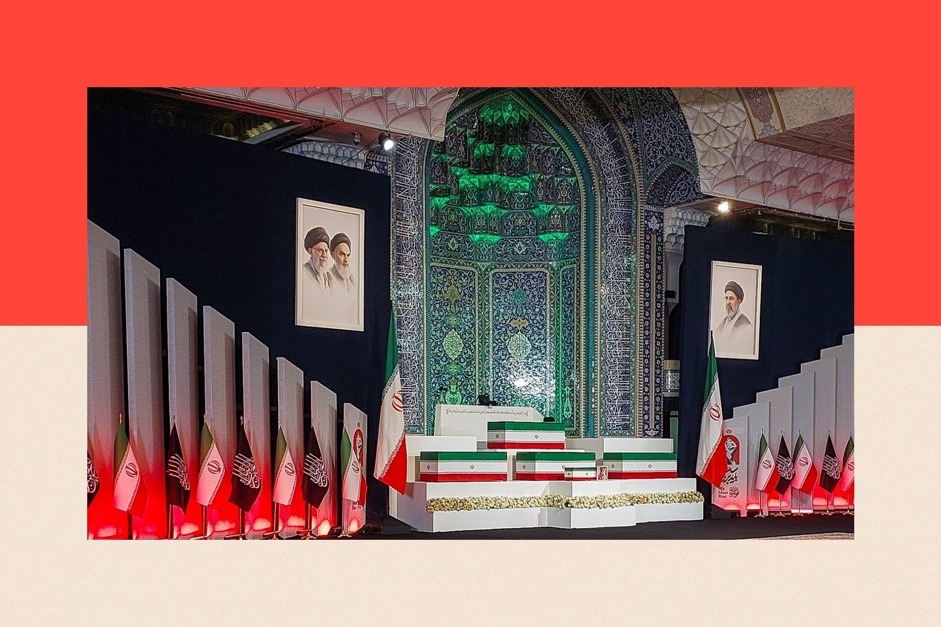 Coffins draped in the Iranian flag sit on a podium flanked by flags and portraits of the ayatollahs