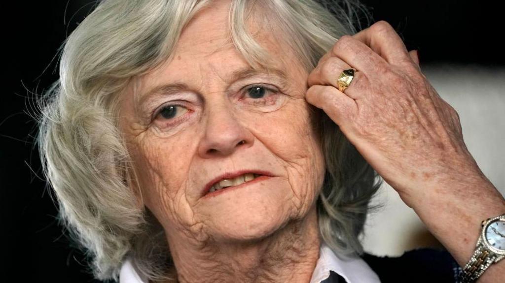 Ann Widdecombe speaks at a rally in 2019 - she wearing a white shirt and black top and parting her hair