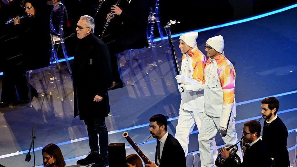 Franco Baresi and Giuseppe Bergomi carry the Olympic torch at the Winter Olympics