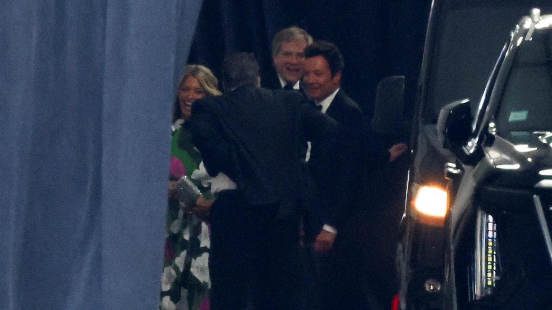 US TV presenter Jimmy Fallon arrives at Madison Square Garden behind a dark curtain.