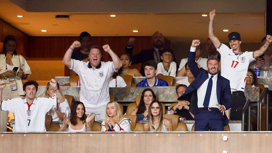 Victoria Beckham appeared stone-faced as her family react with cheers to England's victory against Norway at last week's match