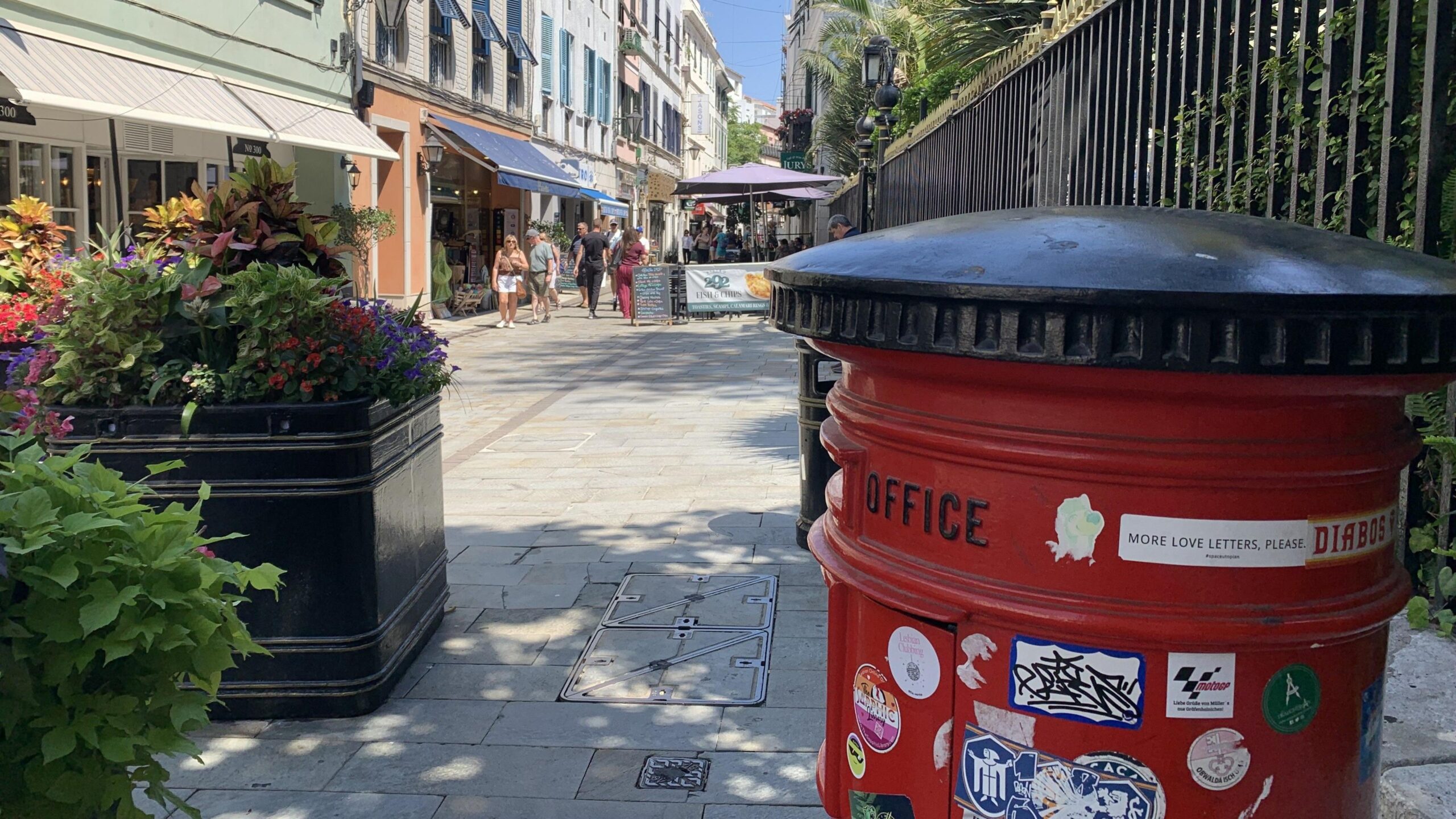 A red British post box on a street in Gibraltar