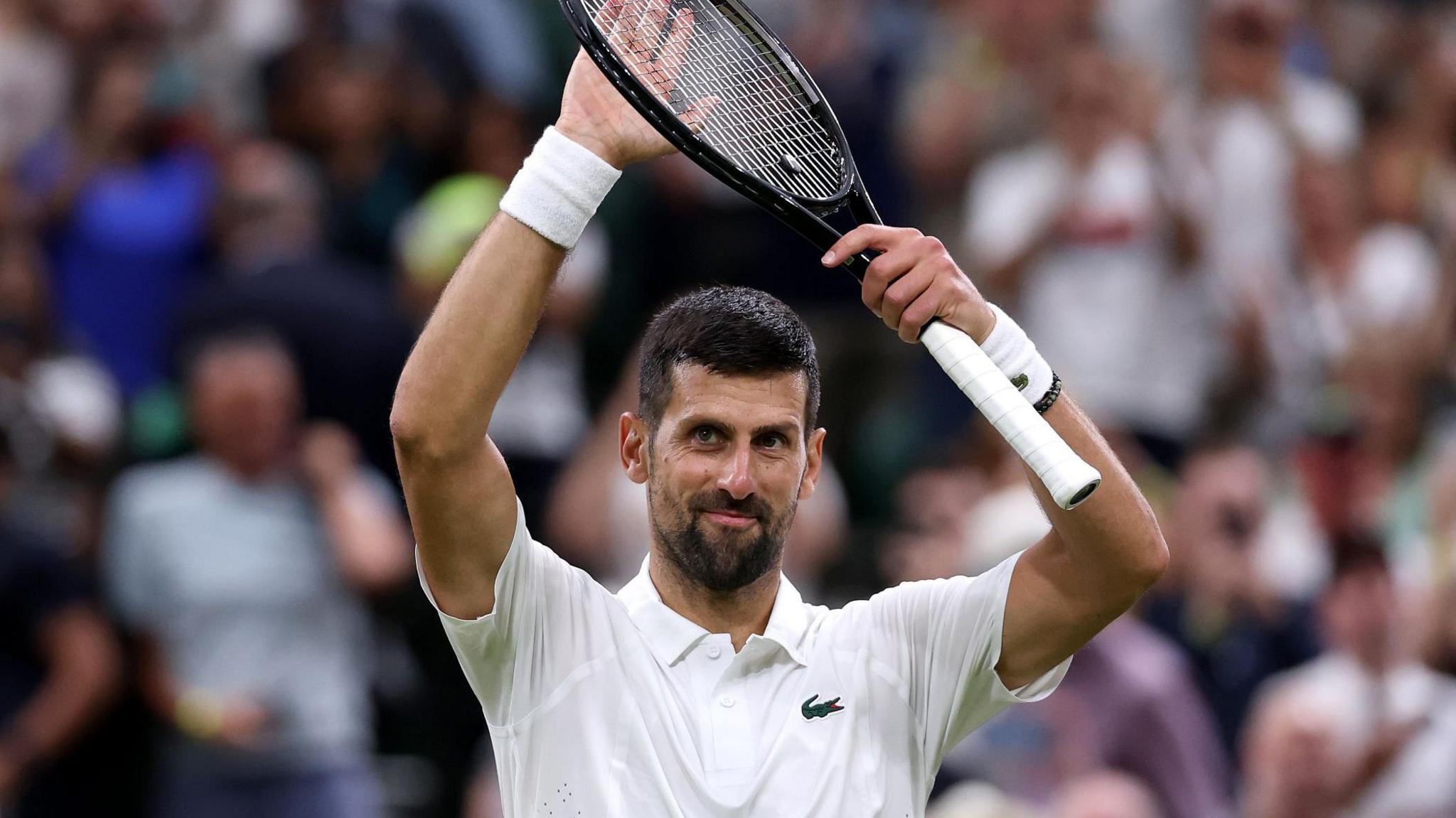Novak Djokovic applauds the crowd after reaching the Wimbledon third round