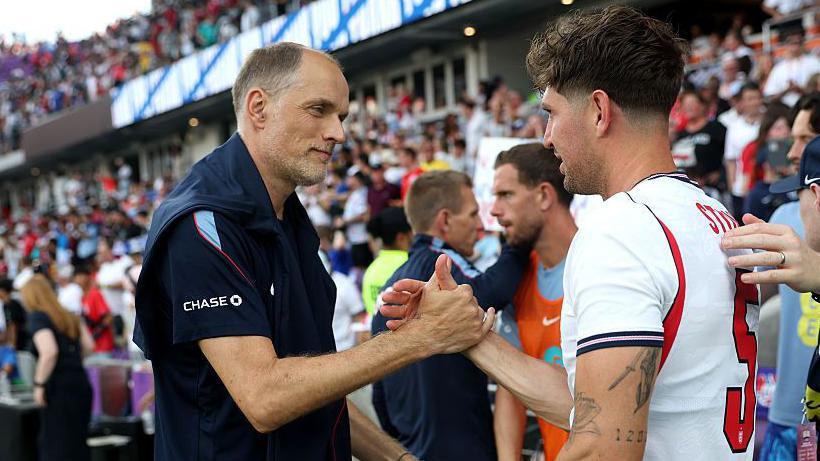 Thomas Tuchel shakes hands with John Stones