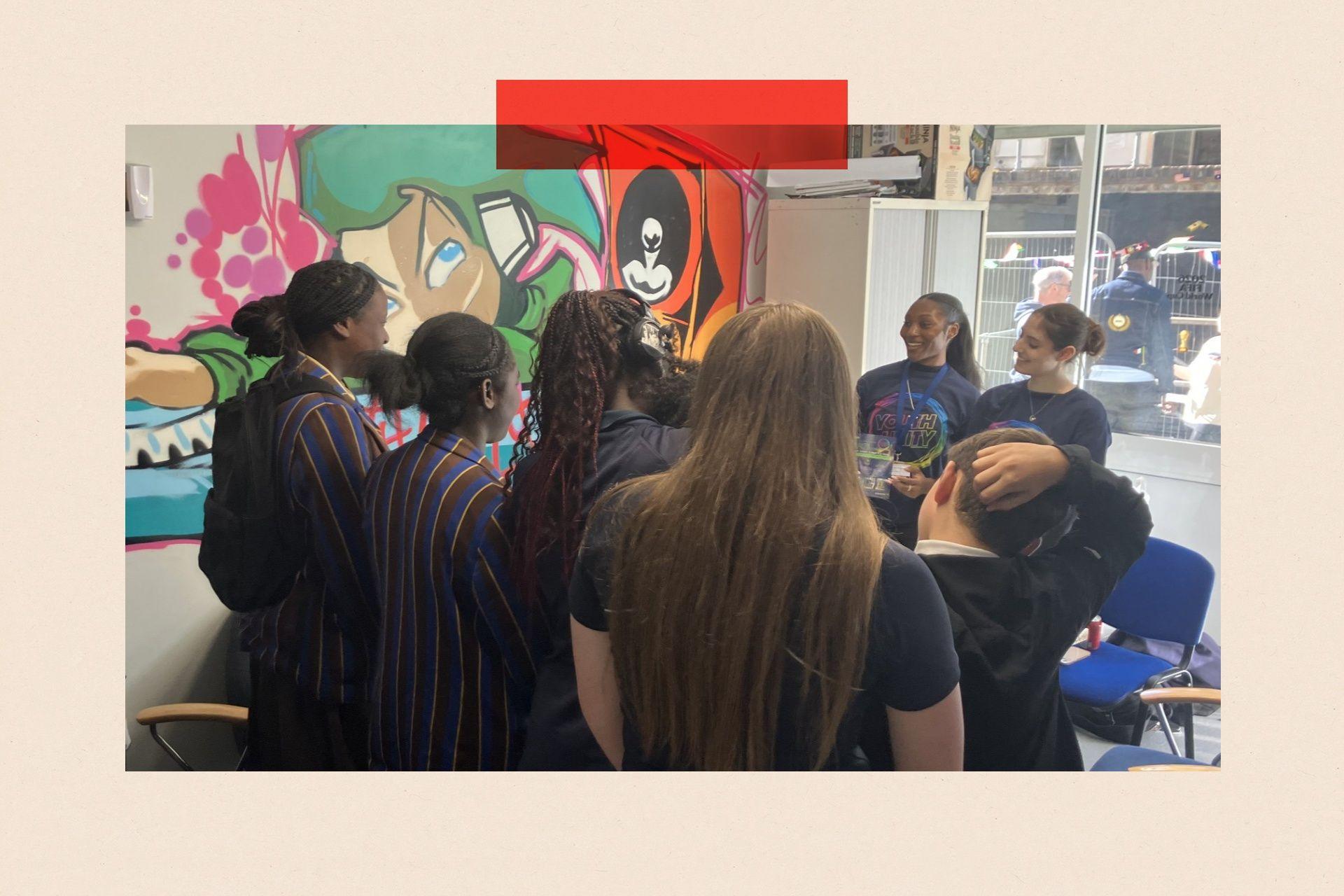 A group of girls huddle together in Youth Unity