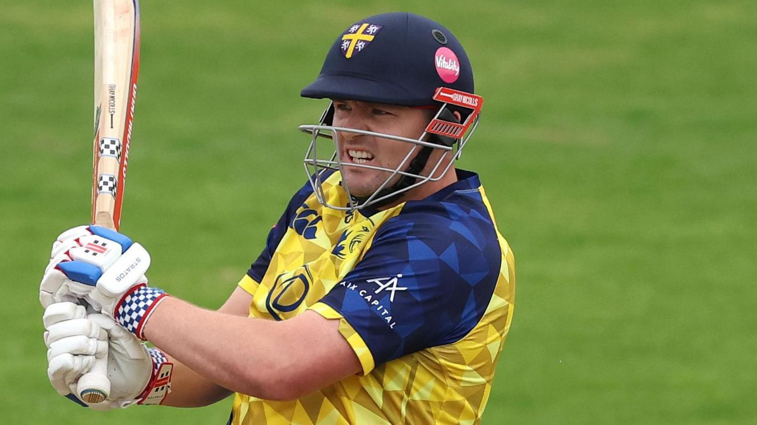 Alex Lees, wearing Durham's yellow and navy blue shirt, batting in a T20 game