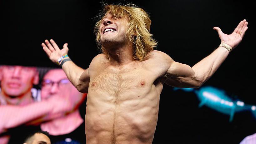 Paddy Pimblett is shirtless and holding up his arms