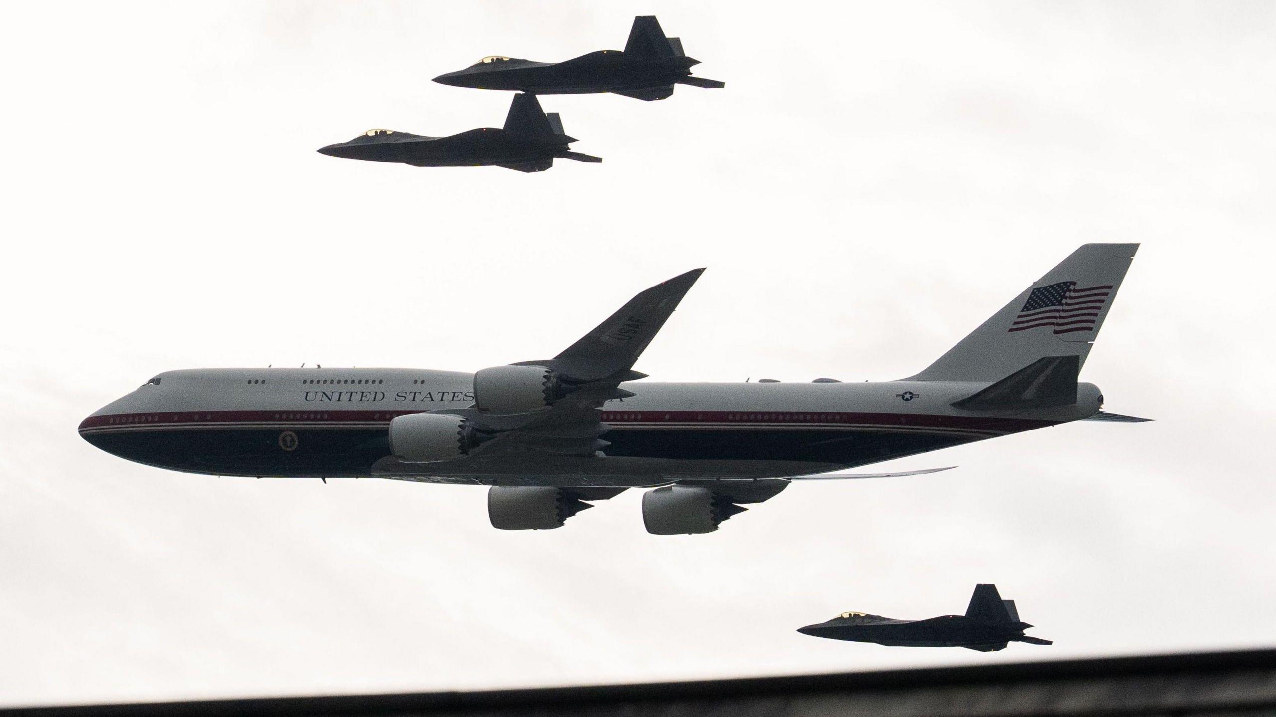 F22 Raptor fighter jets escort the new version of Air Force One as they fly over the National Mall during the Salute to America Semiquincentennial celebration in Washington
