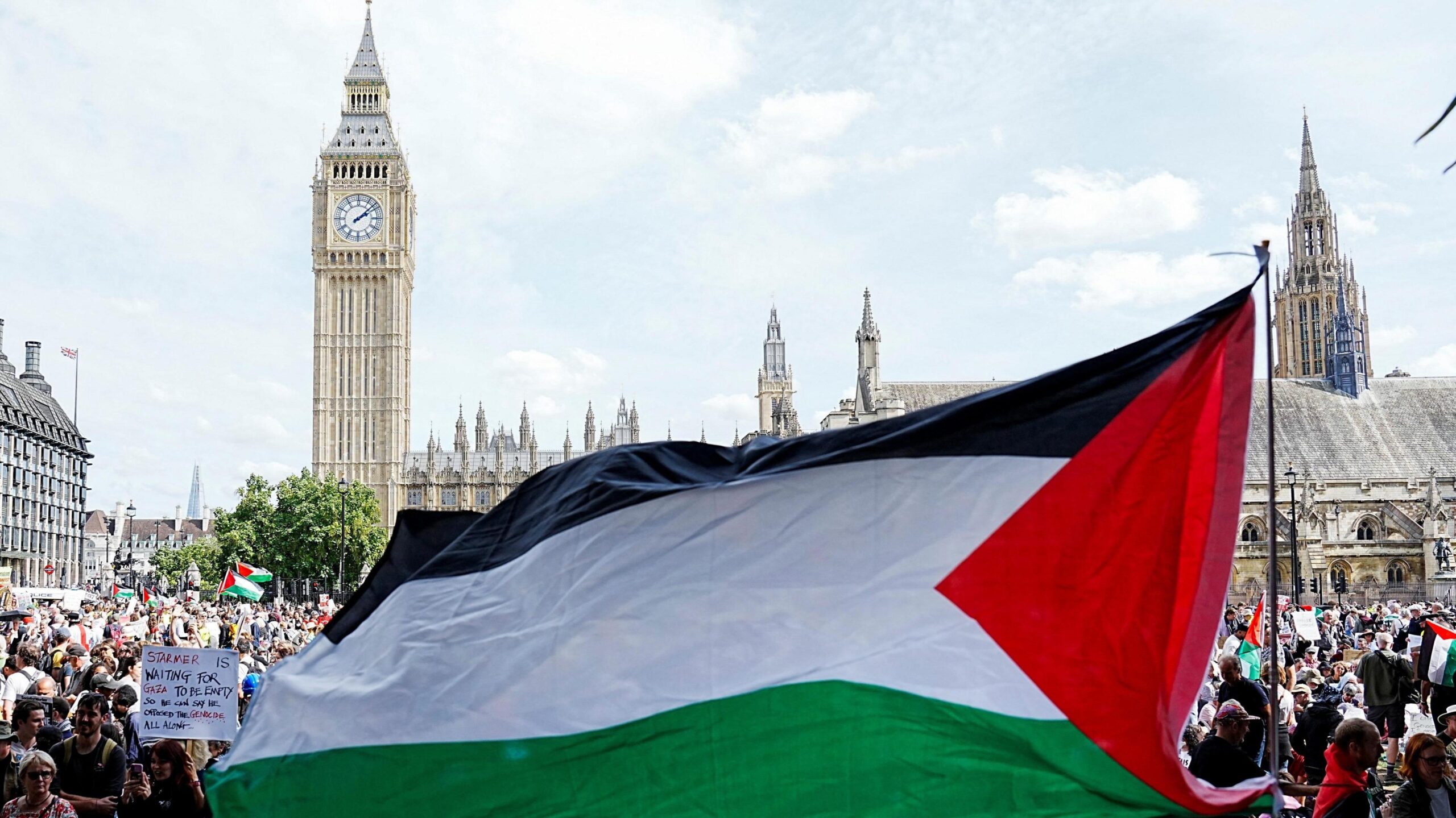 A Palestinian flag is flown by demonstrators at the Lift The Ban rally, challenging the British government's proscription of Palestine Action under anti-terrorism laws, in Parliament Square, London