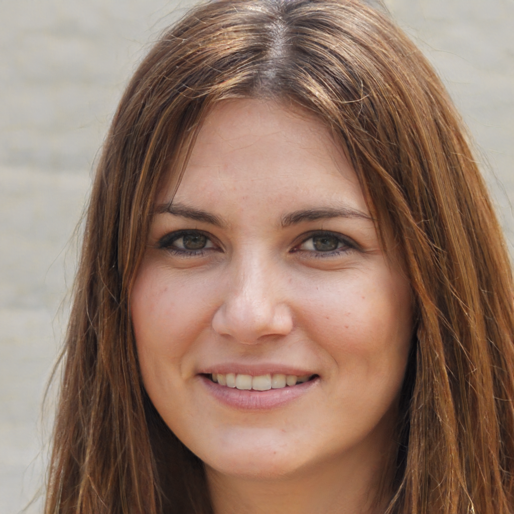 A young woman with shoulder length brown hair smiling at the camera