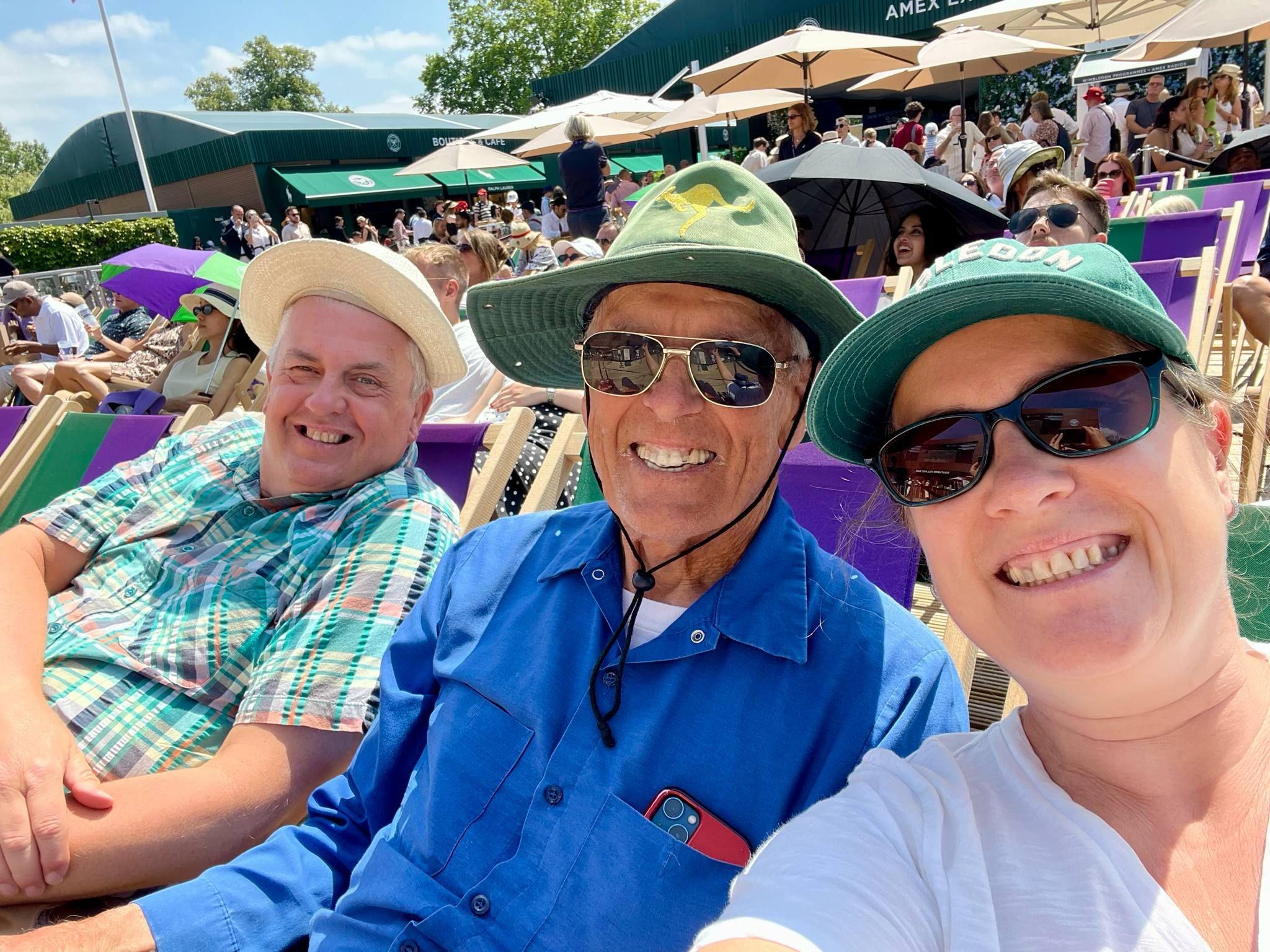Lucy and her friends Richard and Phil are sitting in deckchairs in the Wimbledon grounds