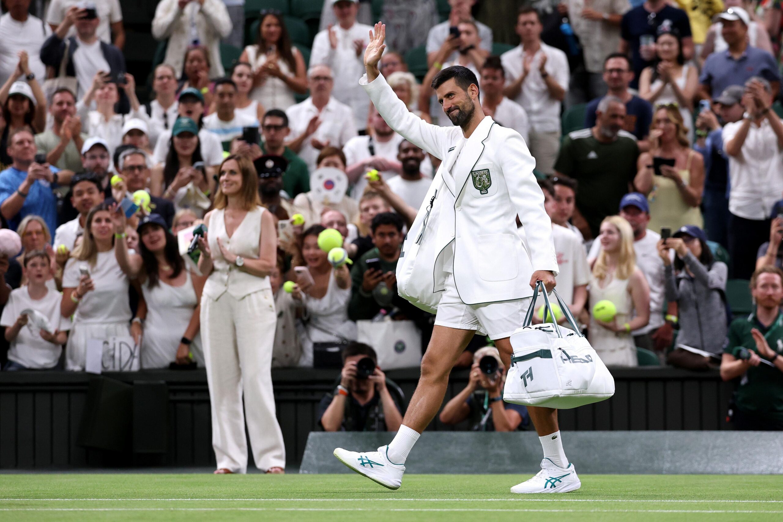 Novak Djokovic leaves court in a blazer after his second-round win